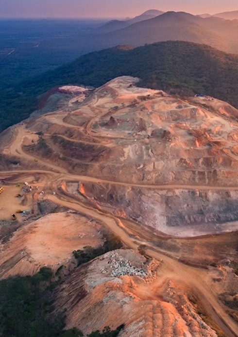 Excavator conducting mineral exploration work